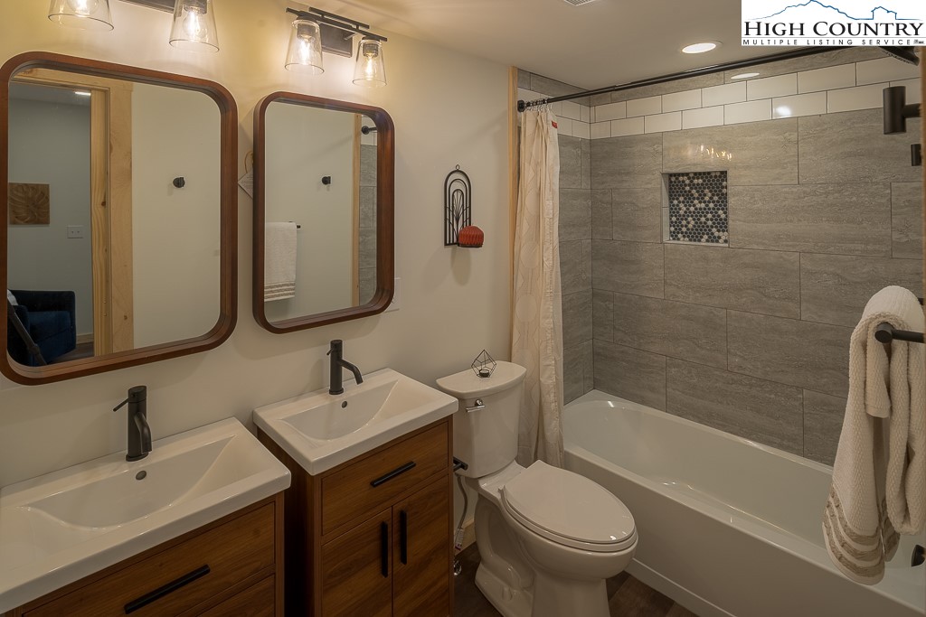 232 Wild Daisy Lane Beech Mountain, NC 28604 - Photo 41 of 49 a bathroom with a sink a toilet and shower