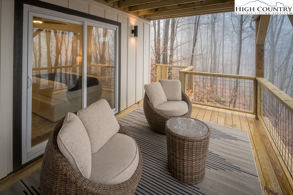 232 Wild Daisy Lane Beech Mountain, NC 28604 - Photo 42 of 49 a living room with furniture and a floor to ceiling window
