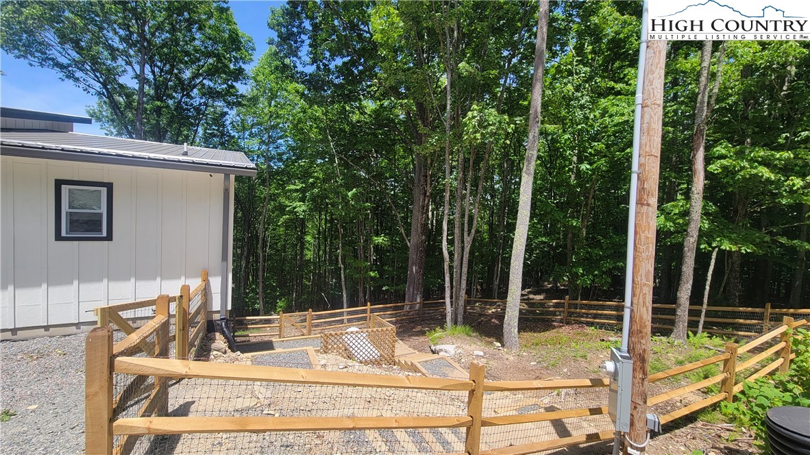 232 Wild Daisy Lane Beech Mountain, NC 28604 - Photo 49 of 49 a view of a house with backyard and sitting area
