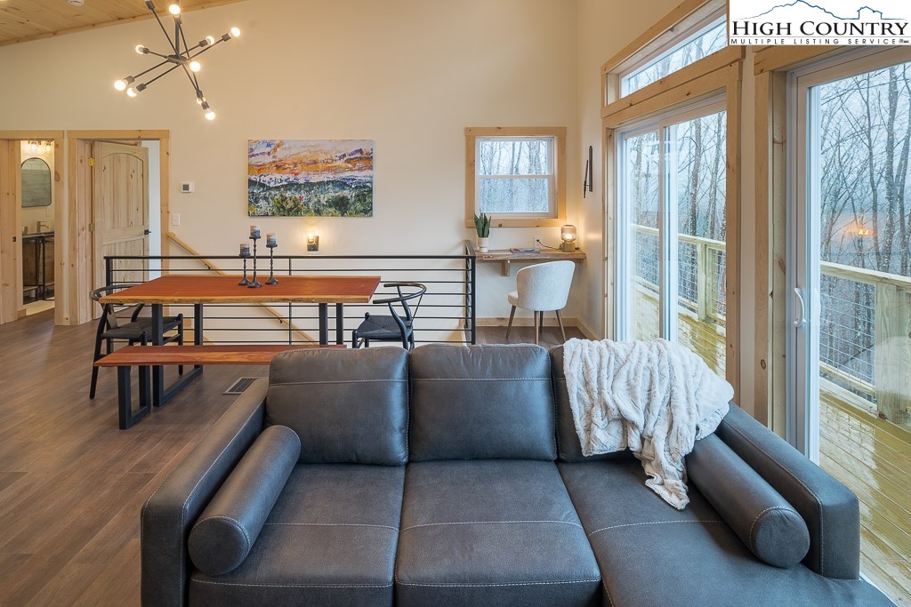 232 Wild Daisy Lane Beech Mountain, NC 28604 - Photo 6 of 49 a living room with furniture and a large window