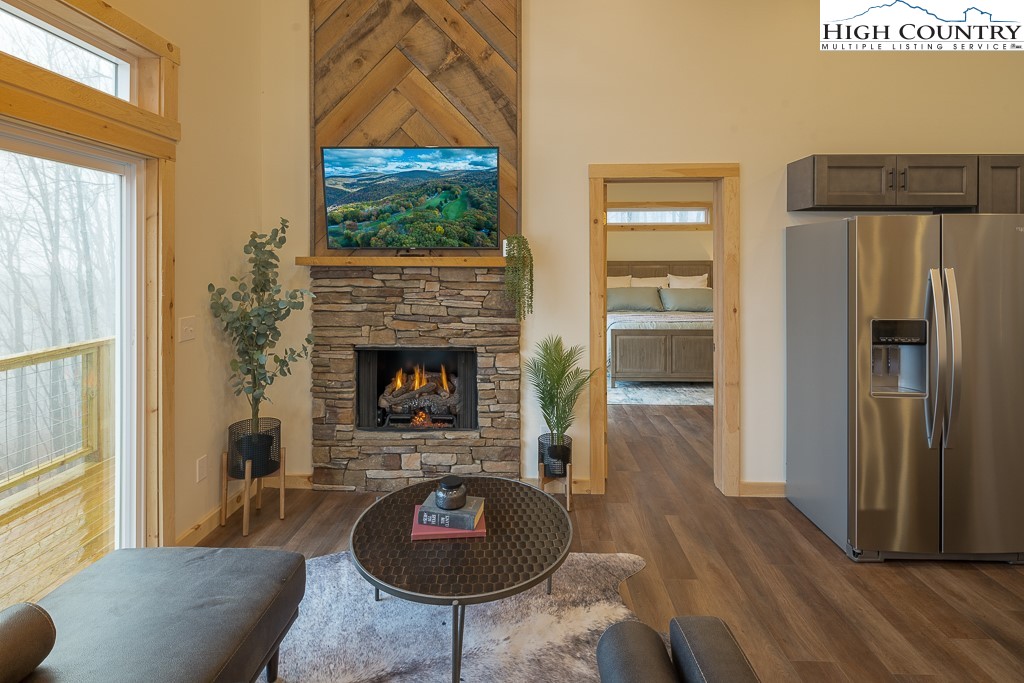 232 Wild Daisy Lane Beech Mountain, NC 28604 - Photo 7 of 49 a living room with furniture and a fireplace