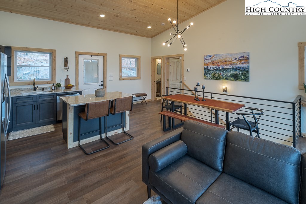 232 Wild Daisy Lane Beech Mountain, NC 28604 - Photo 10 of 49 a living room with furniture kitchen view and a wooden floor
