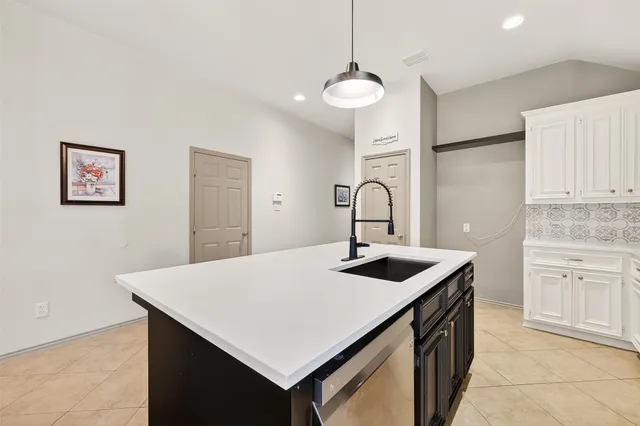 a kitchen that has a sink a stove and a refrigerator