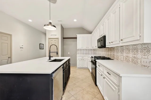a kitchen with stainless steel appliances a sink stove and cabinets