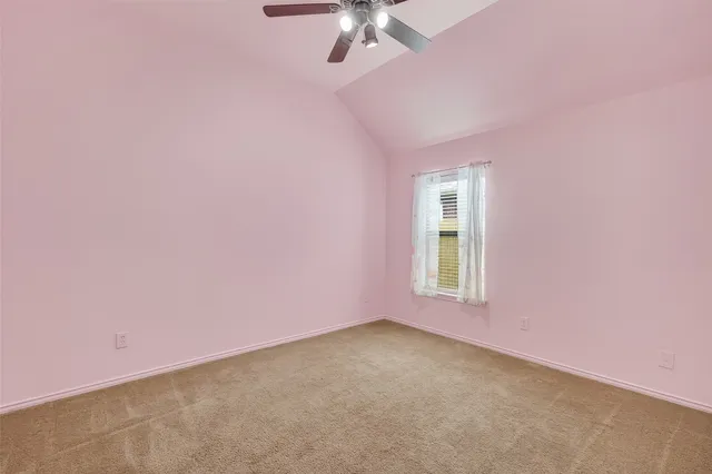 a view of a livingroom with a ceiling fan and window