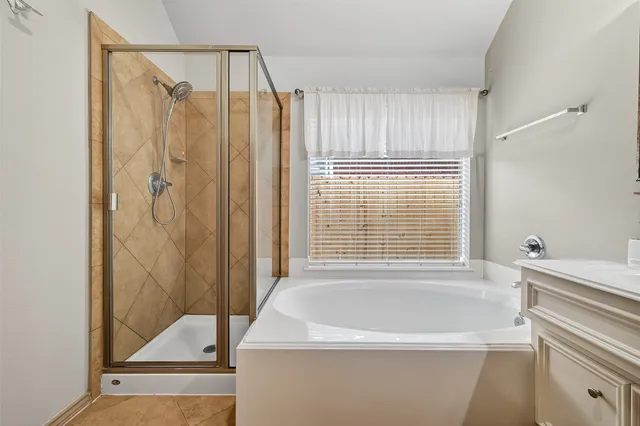 a bathroom with a tub and a shower