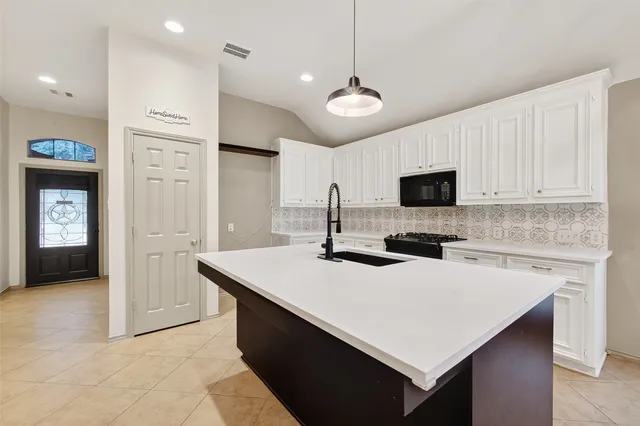 a kitchen with a stove a sink and a refrigerator