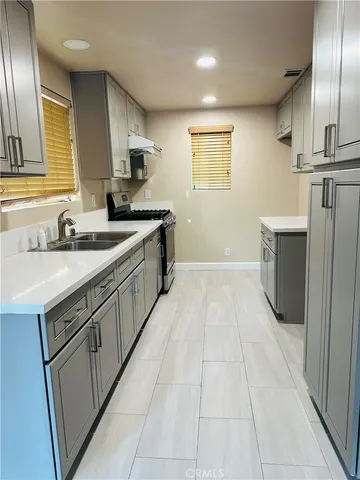 a kitchen with a sink cabinets and appliances
