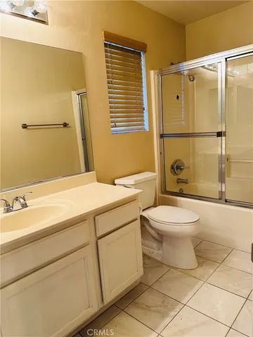 a bathroom with a granite countertop toilet sink and shower