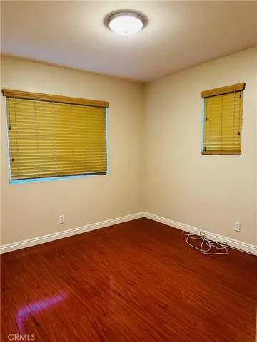 a view of a room with wooden floor and a window