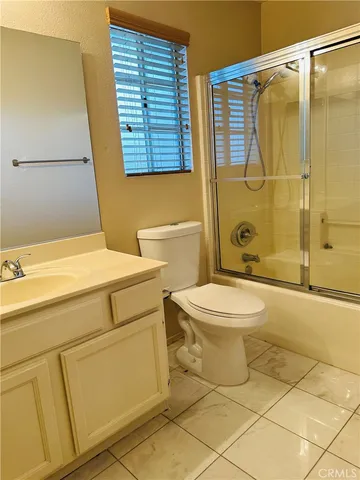 a bathroom with a toilet sink and shower
