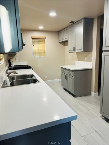 a kitchen with stainless steel appliances a stove a microwave a sink and a refrigerator