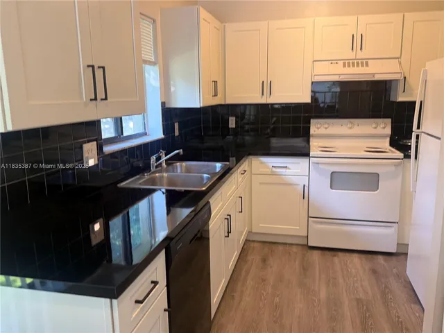 a kitchen with a stove and a sink