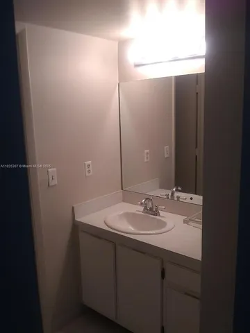 a bathroom with a sink and mirror
