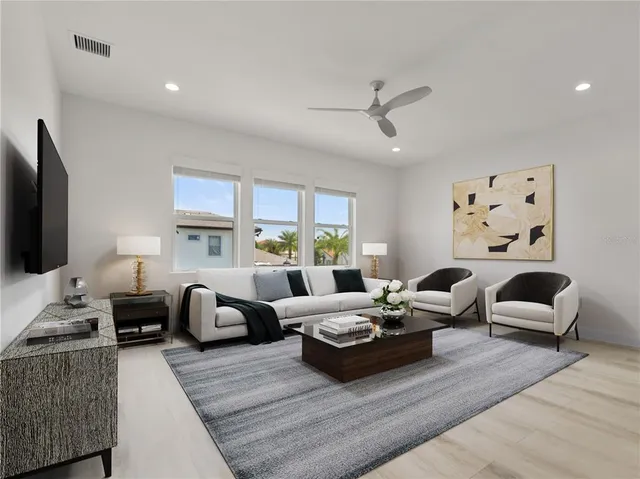 a living room with furniture flat screen tv and window
