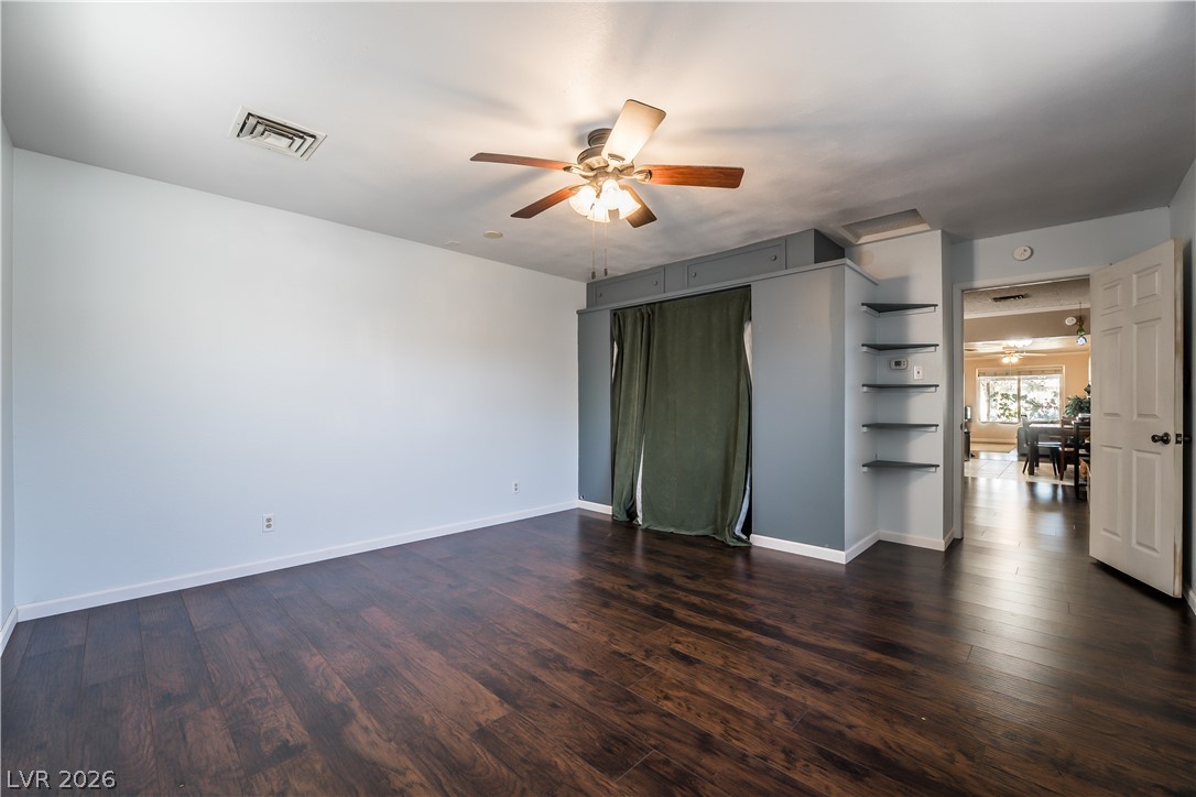 1324 Appaloosa Road Boulder City, NV 89005 - Photo 16 of 42 Rich hardwood floors complement this cozy bedroom, complete with a functional ceiling fan.