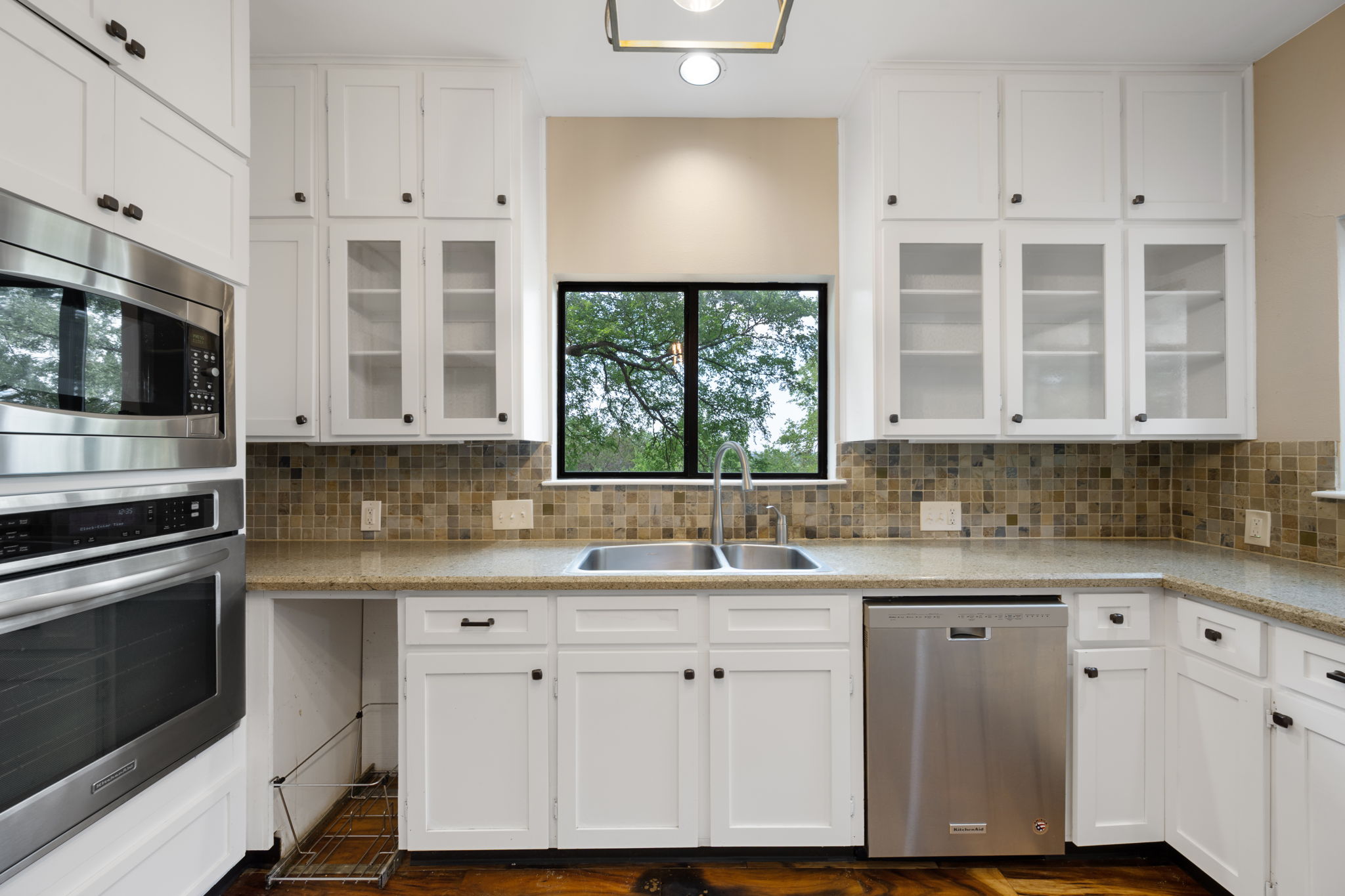 330 County Road 166 Georgetown, TX 78626 - Photo 11 of 40 a kitchen with stainless steel appliances granite countertop a sink a stove a microwave and cabinets