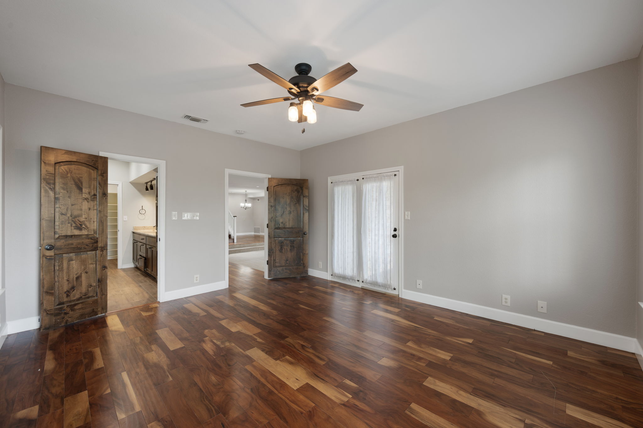 330 County Road 166 Georgetown, TX 78626 - Photo 13 of 40 a view of an empty room with wooden floor and a ceiling fan