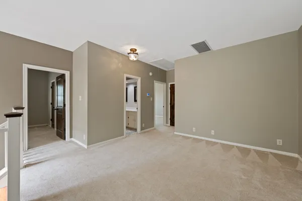 a spacious bathroom with a double vanity sink and a mirror