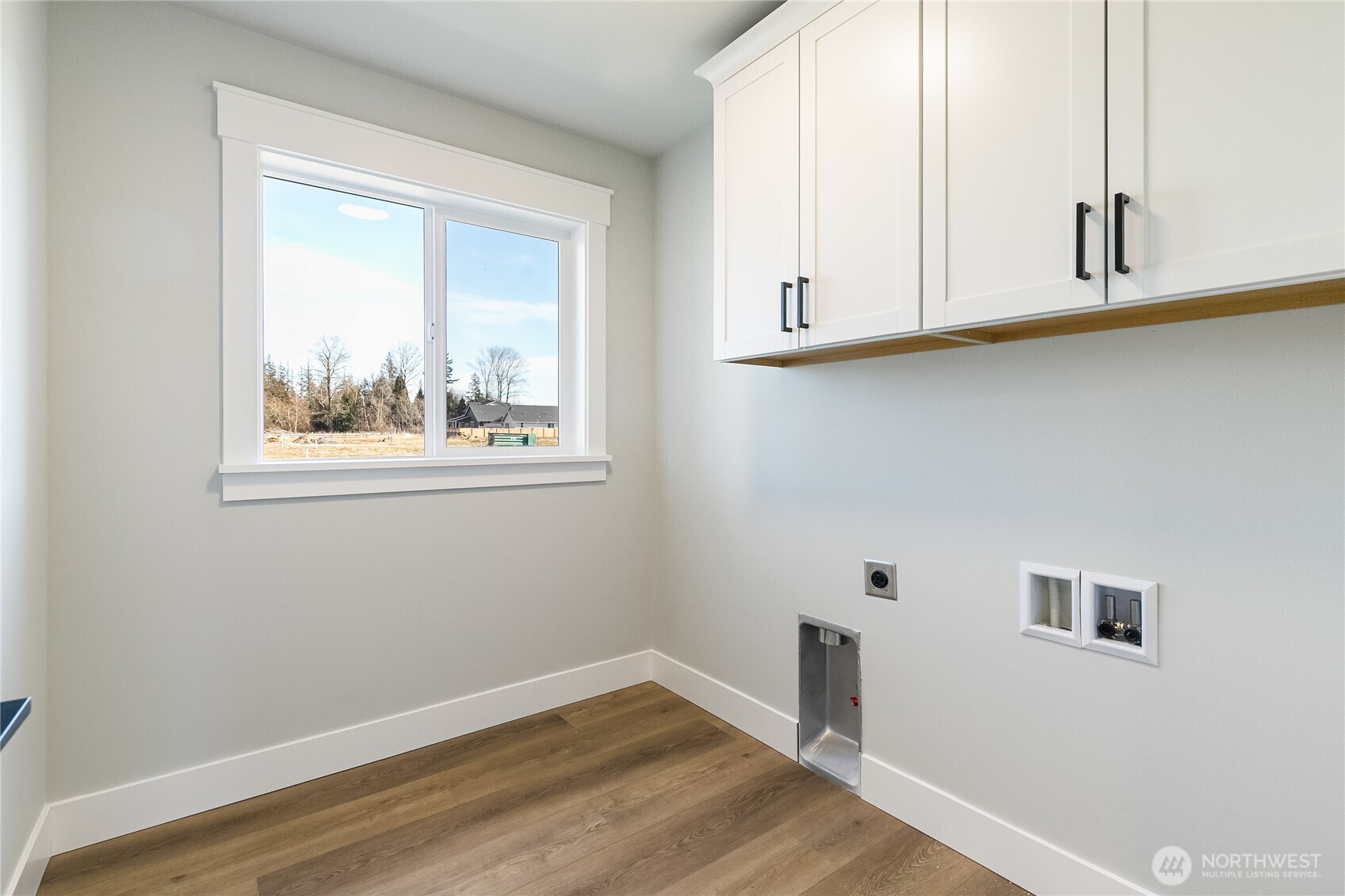 5984 Ranch Loop Ferndale, WA 98248 - Photo 25 of 37 a view of an empty room with wooden floor and a window