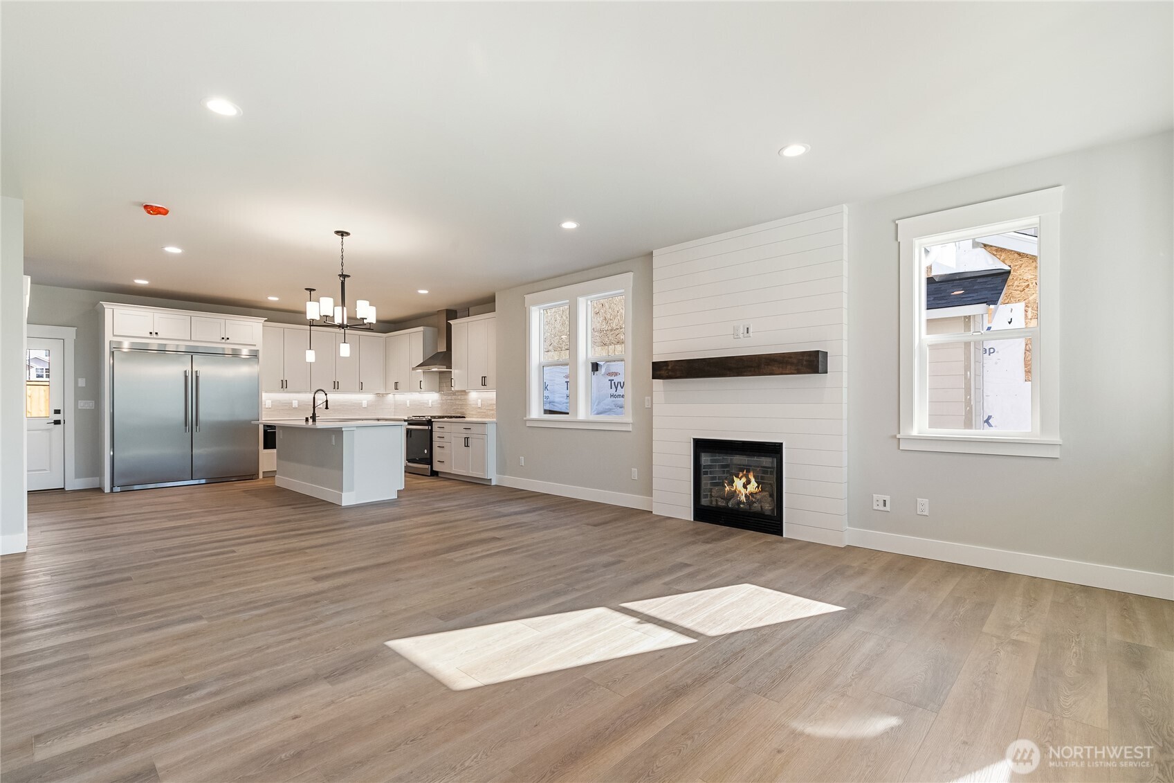 5984 Ranch Loop Ferndale, WA 98248 - Photo 4 of 37 a view of kitchen with fireplace and wooden floor