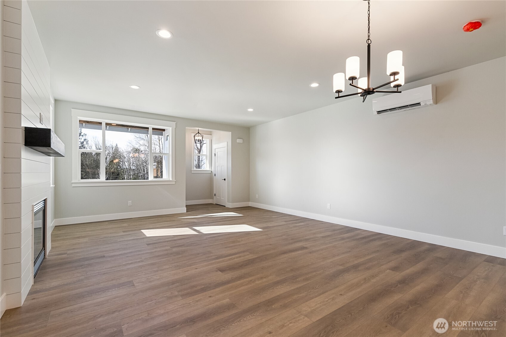 5984 Ranch Loop Ferndale, WA 98248 - Photo 5 of 37 a view of an empty room with a window and wooden floor