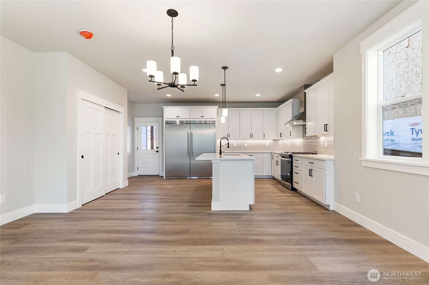 5984 Ranch Loop Ferndale, WA 98248 - Photo 6 of 37 a large white kitchen with lots of counter space a sink refrigerator and cabinets