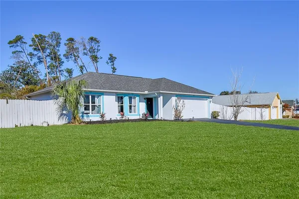 a front view of a house with a garden and yard