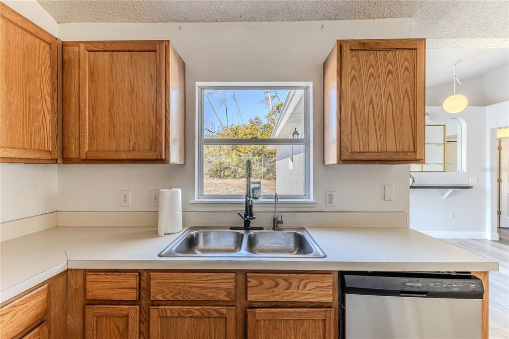 5437 Freeport Drive Spring Hill, FL 34606 - Photo 11 of 34 a kitchen with a sink cabinets and window
