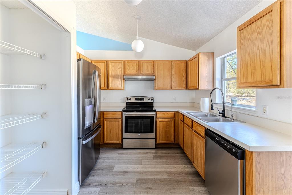 5437 Freeport Drive Spring Hill, FL 34606 - Photo 12 of 34 a kitchen with a sink stove top oven and cabinets