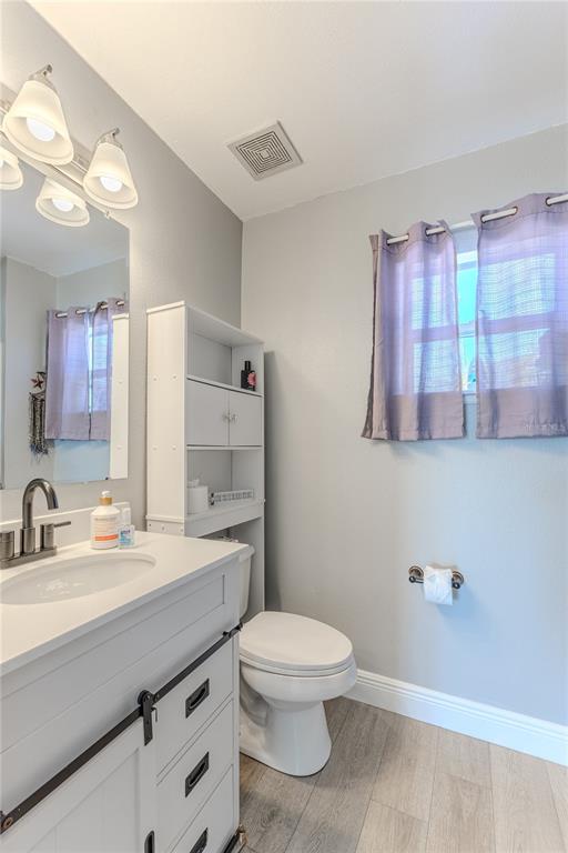 5437 Freeport Drive Spring Hill, FL 34606 - Photo 15 of 34 a bathroom with a double vanity sink toilet and a mirror