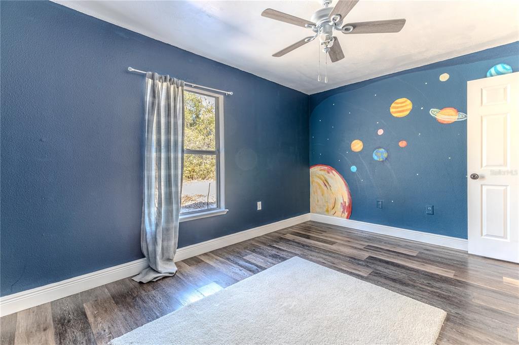 5437 Freeport Drive Spring Hill, FL 34606 - Photo 16 of 34 a bedroom with a bed and a window