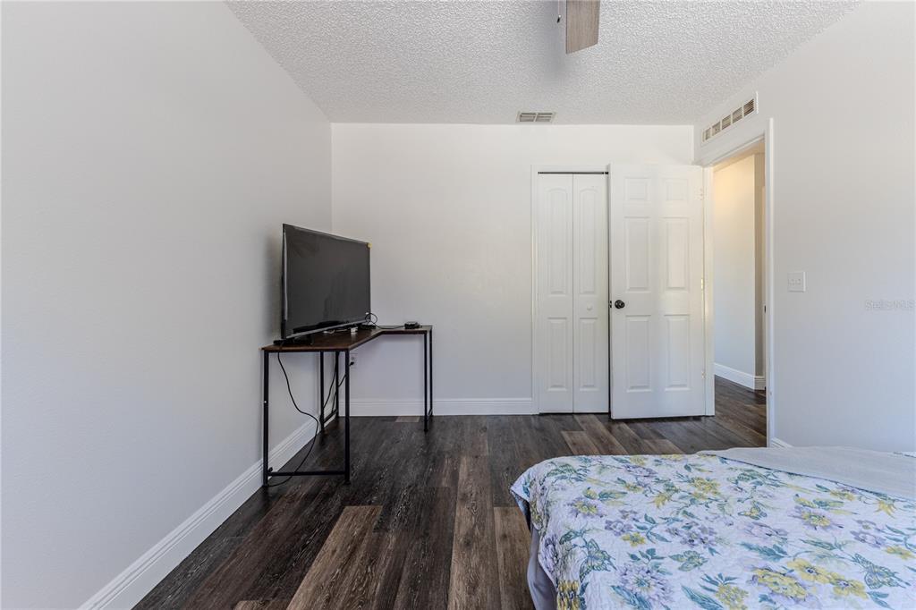 5437 Freeport Drive Spring Hill, FL 34606 - Photo 18 of 34 a bedroom with a bed and a flat screen tv