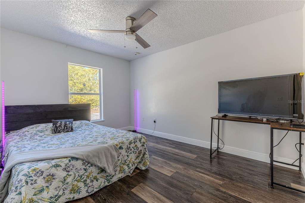 5437 Freeport Drive Spring Hill, FL 34606 - Photo 19 of 34 a bedroom with a bed and a flat screen tv