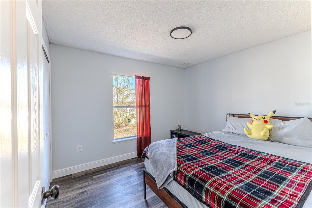 5437 Freeport Drive Spring Hill, FL 34606 - Photo 20 of 34 a bedroom with a bed and wooden floor