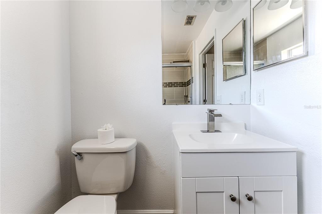 5437 Freeport Drive Spring Hill, FL 34606 - Photo 23 of 34 a bathroom with a toilet sink and mirror