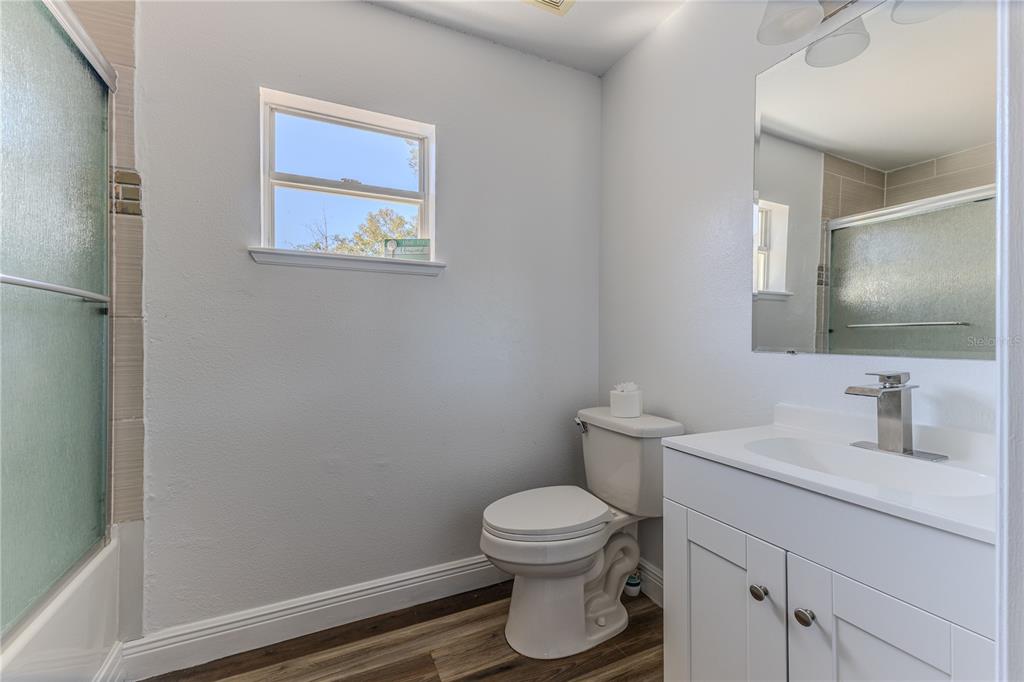 5437 Freeport Drive Spring Hill, FL 34606 - Photo 24 of 34 a bathroom with a toilet sink and mirror