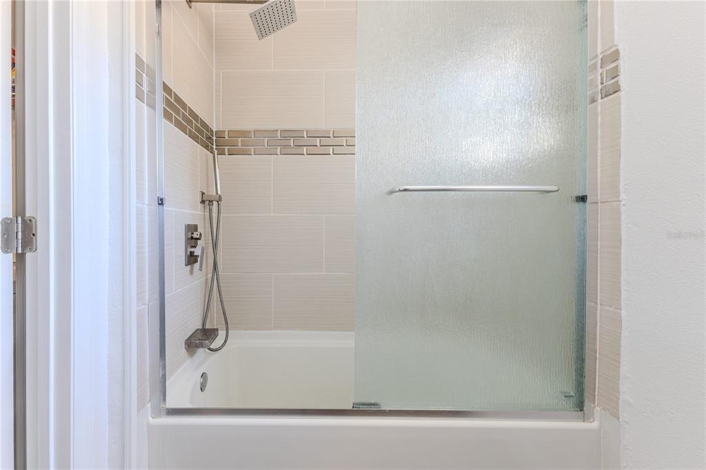 5437 Freeport Drive Spring Hill, FL 34606 - Photo 25 of 34 a bathroom with a glass shower door
