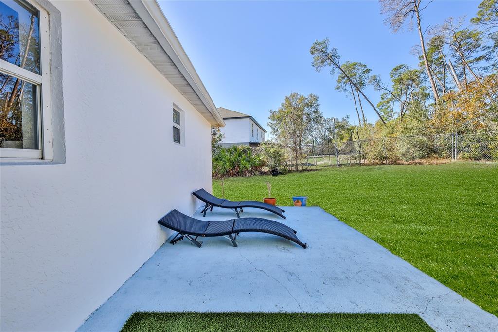 5437 Freeport Drive Spring Hill, FL 34606 - Photo 27 of 34 a wooden bench sitting in backyard of a house