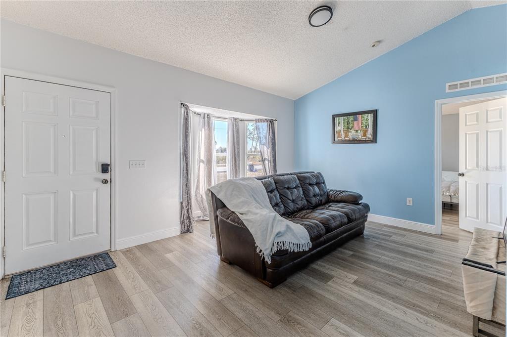 5437 Freeport Drive Spring Hill, FL 34606 - Photo 3 of 34 a living room with furniture and a wooden floor