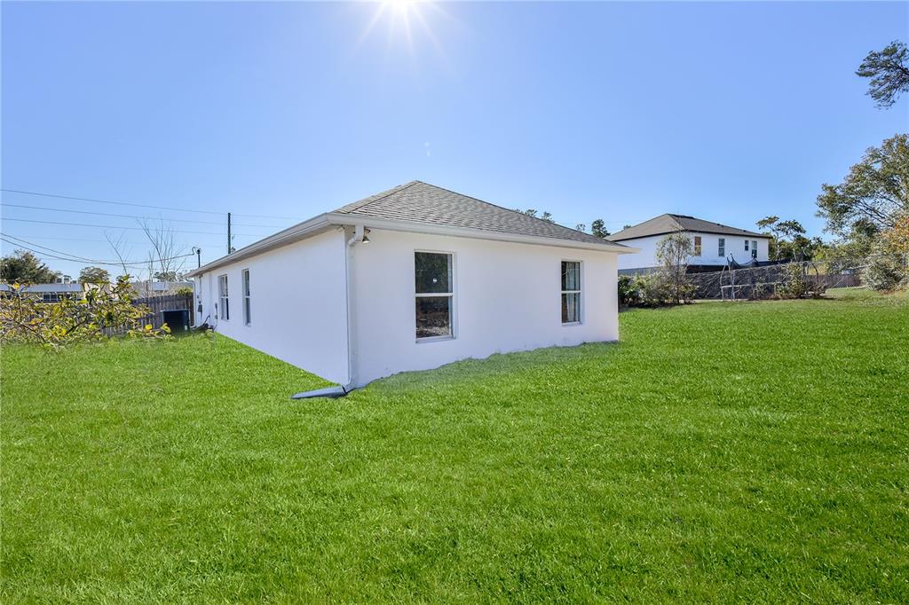 5437 Freeport Drive Spring Hill, FL 34606 - Photo 31 of 34 a view of a house with backyard and garden