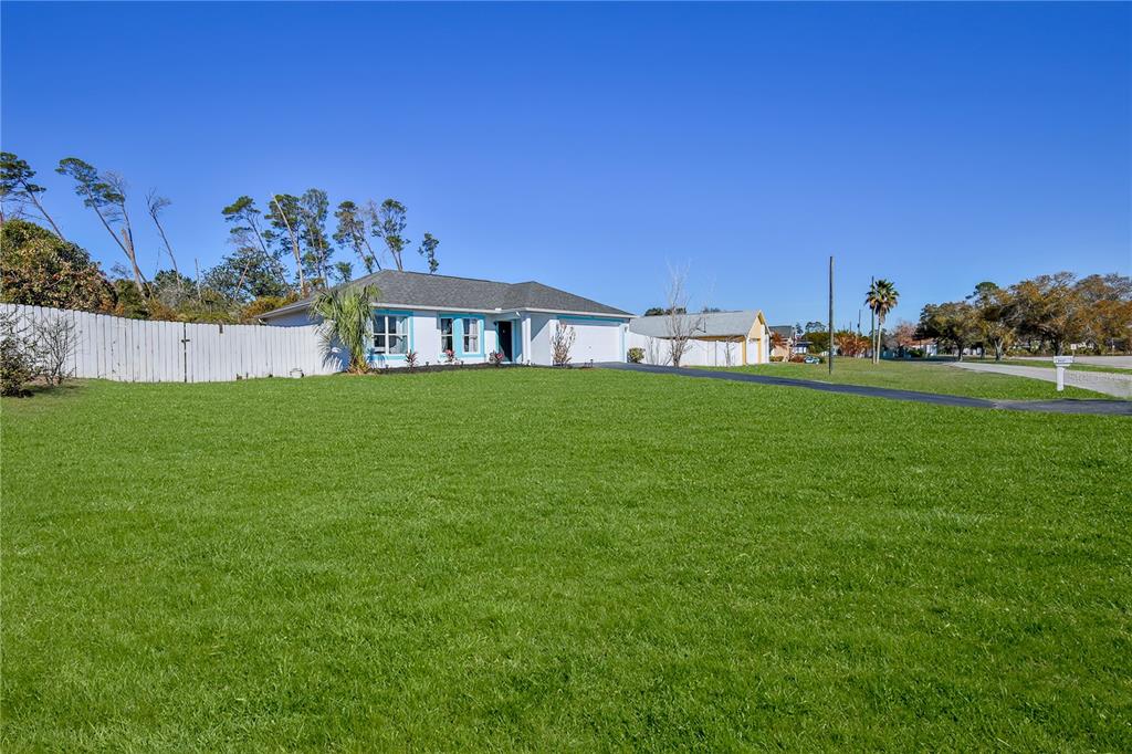 5437 Freeport Drive Spring Hill, FL 34606 - Photo 34 of 34 a view of a big yard with a house in the background