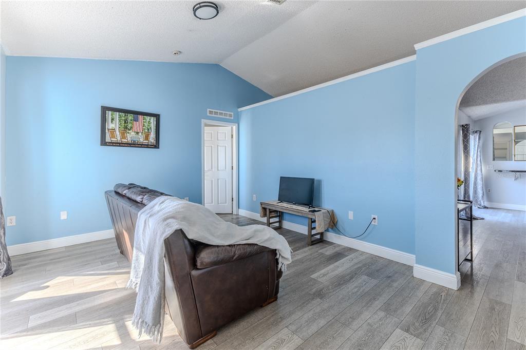 5437 Freeport Drive Spring Hill, FL 34606 - Photo 4 of 34 a living room with furniture wooden floor and a flat screen tv