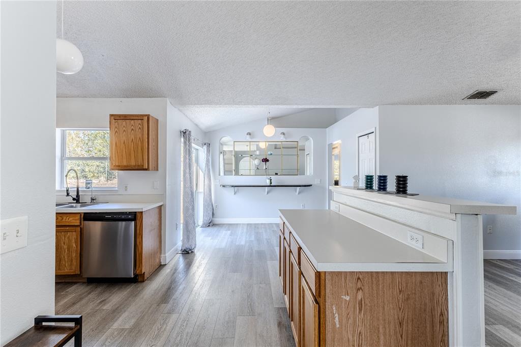 5437 Freeport Drive Spring Hill, FL 34606 - Photo 6 of 34 a large kitchen with a lot of counter space and wooden floor