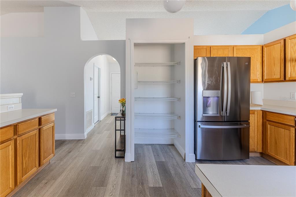 5437 Freeport Drive Spring Hill, FL 34606 - Photo 7 of 34 a kitchen with stainless steel appliances granite countertop a refrigerator and a stove top oven