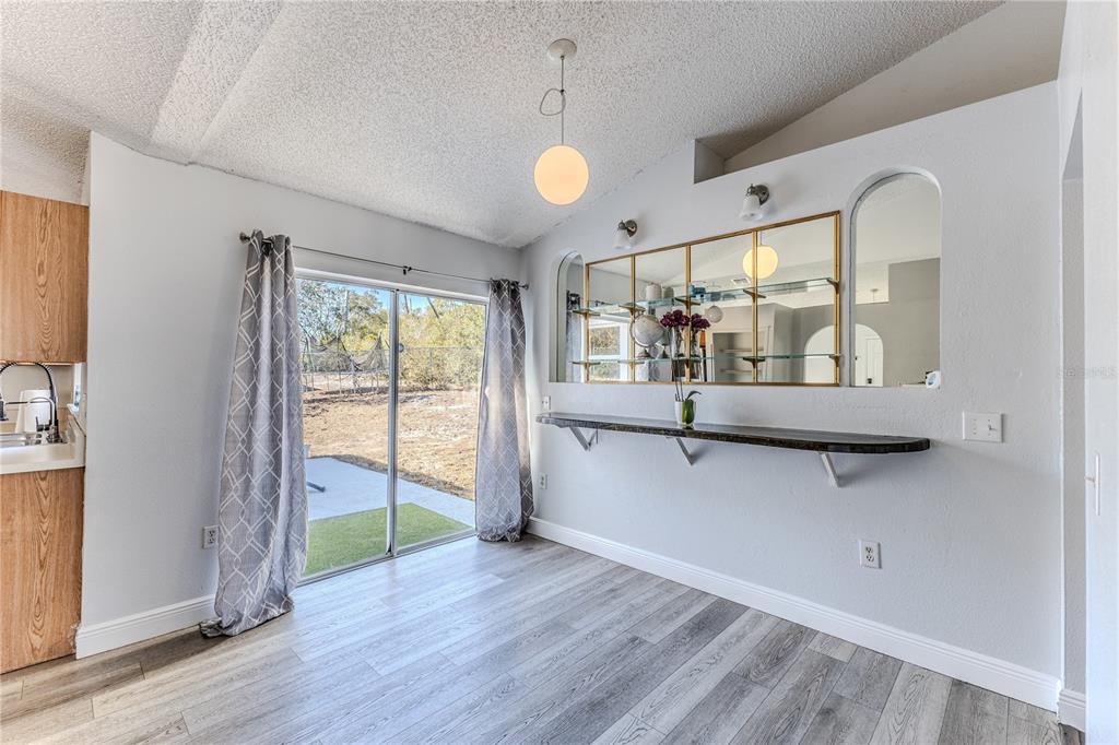 5437 Freeport Drive Spring Hill, FL 34606 - Photo 9 of 34 a view of an entryway with wooden floor and door