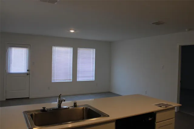a kitchen with a sink cabinets and window