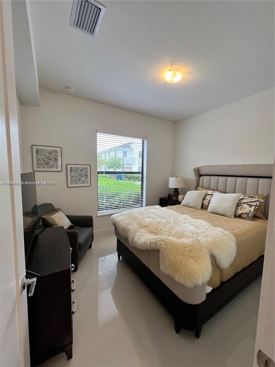 Kendall Miami, FL 33186 - Photo 12 of 30 a bedroom with a bed and window