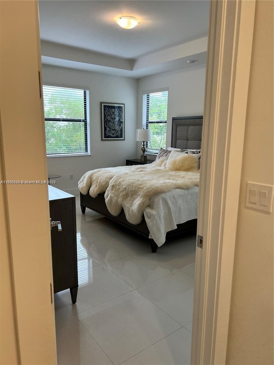 Kendall Miami, FL 33186 - Photo 15 of 30 a bed sitting in a bedroom next to a window