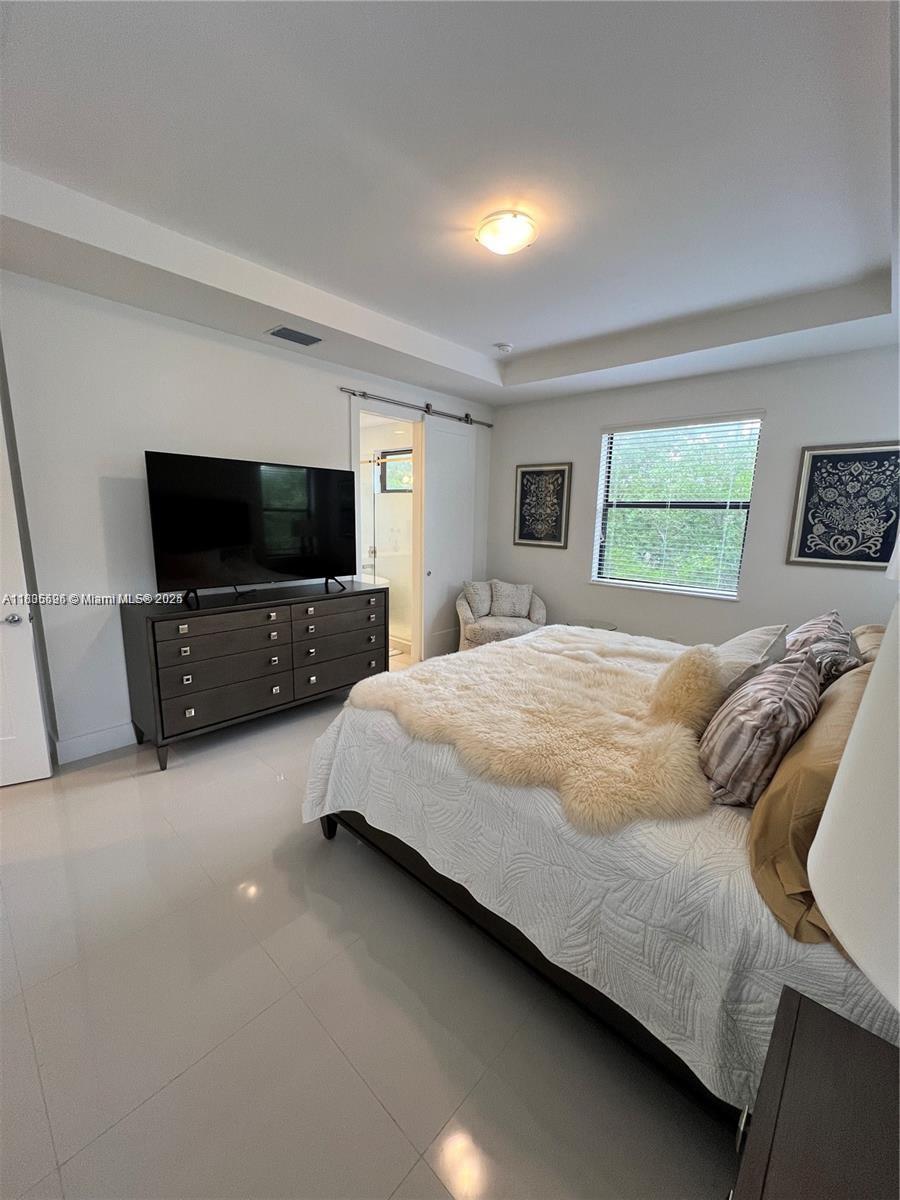 Kendall Miami, FL 33186 - Photo 17 of 30 a bedroom with a bed and a flat screen tv